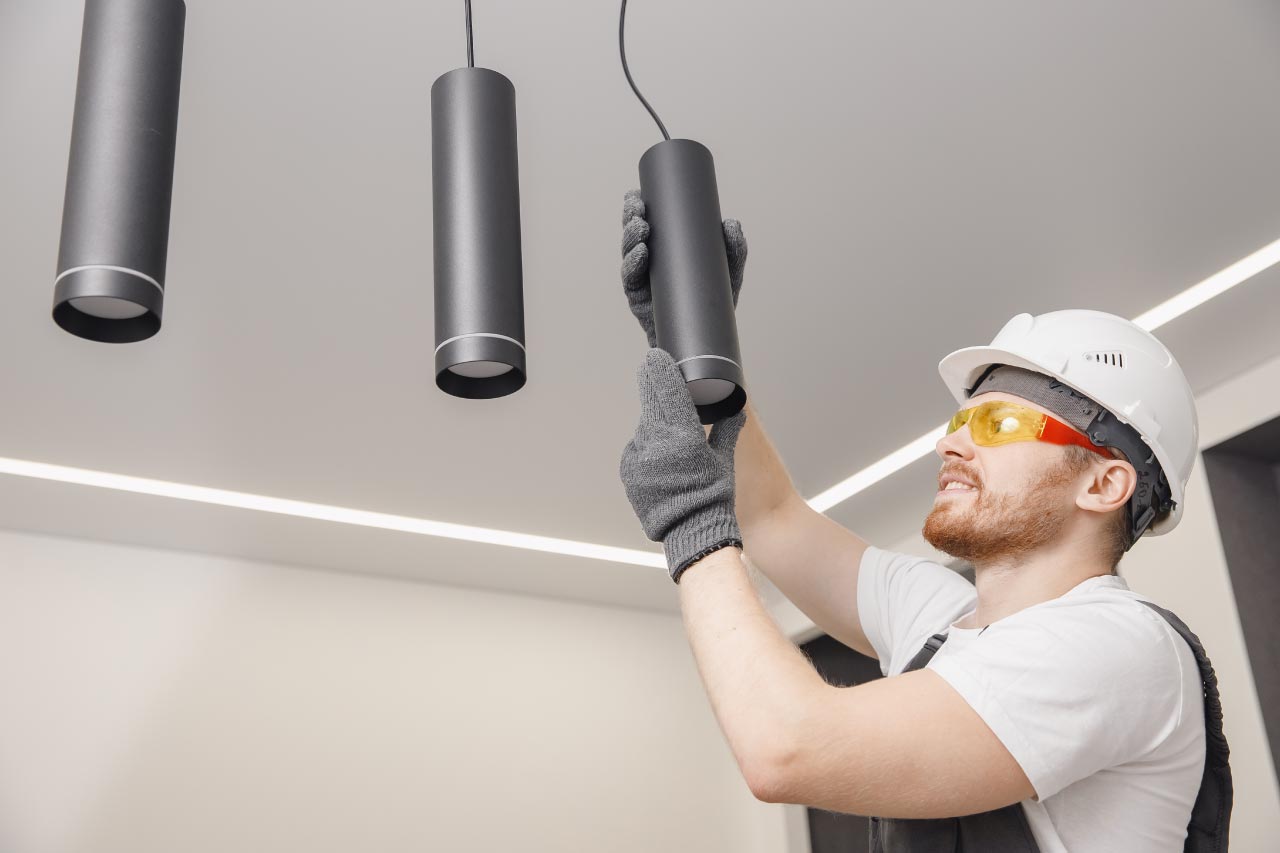 Electrician installing pendant lights