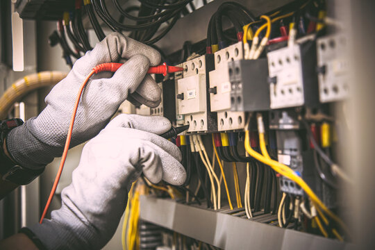 Electrician testing electrical panel